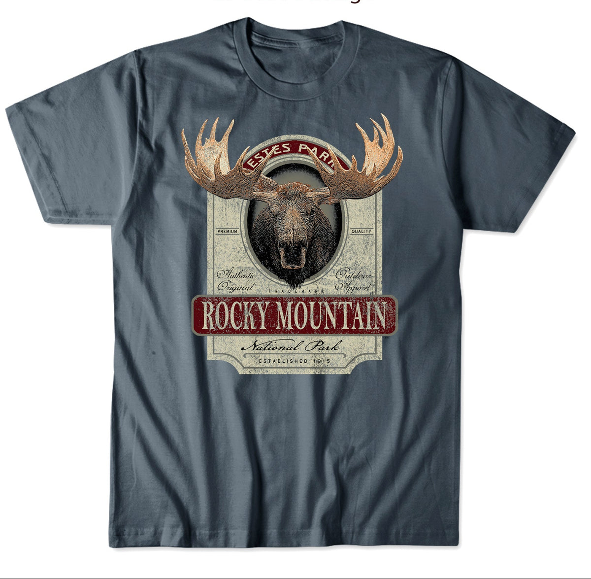 A dark slate blue t-shirt featuring a large front graphic of a moose head with antlers and a vintage whiskey label design that reads 'Rocky Mountain National Park' and 'Texas Pale'. The image includes a top graphic preview of the print and a bottom mockup of the t-shirt on a white background.